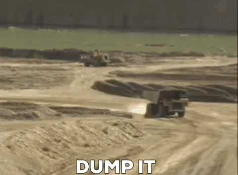 Dump Truck Driving Down Dirt Road Saying Dump It