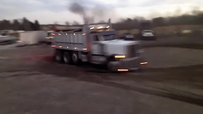 Dump Truck Driving With Smoke From Back GIF