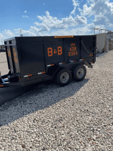 Dumpster with B & B Sign