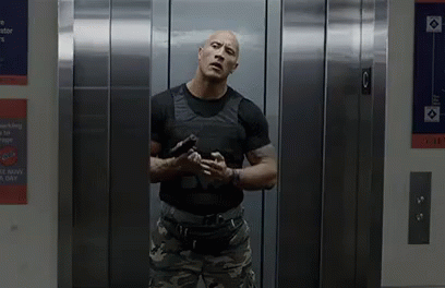 Dwayne Johnson On Elevator Loading Gun GIF