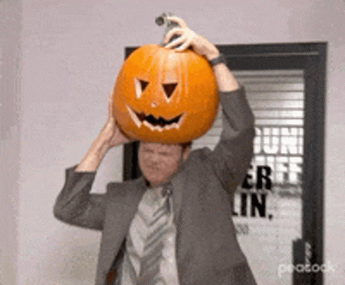 Rainn Wilson Taking Off The Pumpkin GIF