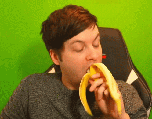 Streamer In Green Background Eating Banana GIF
