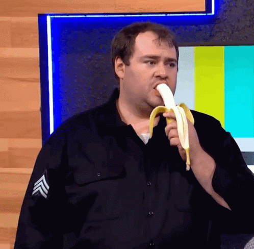 Man In Black Uniform Eating Banana GIF