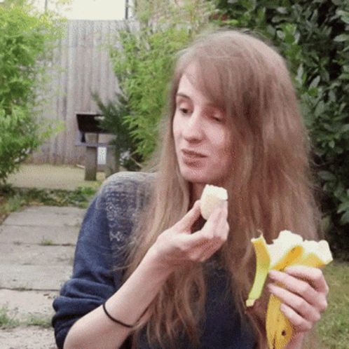 Long Haired Girl Eating Banana GIF
