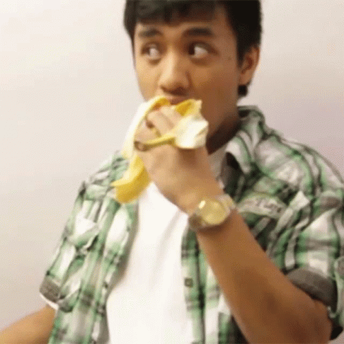 Dude Wearing Short Sleeve Polo Eating Banana GIF