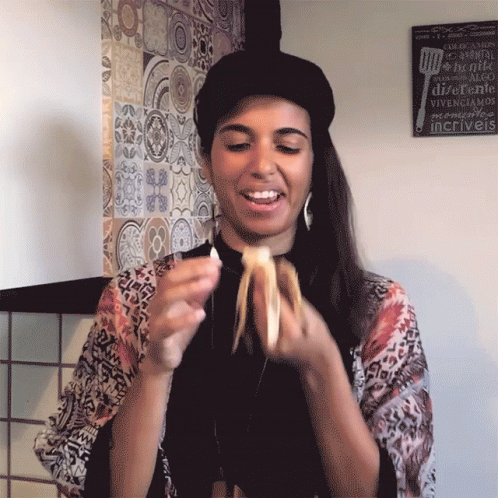 Woman Wearing Black Cap Eating Banana GIF