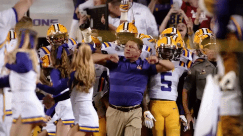 Ed Orgeron With His Players Behind Him GIF