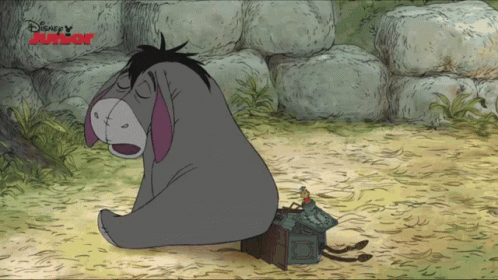 Eeyore Sitting in Dirt Next to Disney Junior Sign