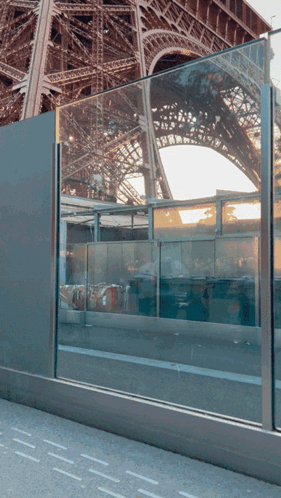 Eiffel Tower Reflected In Glass Barrier GIF