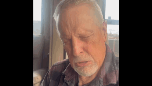 Elderly Bearded Man Sitting By Window GIF