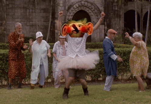 Elderly Dancing in Park With Man in Tutu