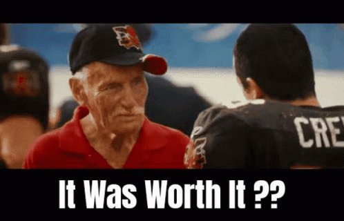 Elderly Man in Baseball Cap Talking to Young Man in Football Jersey