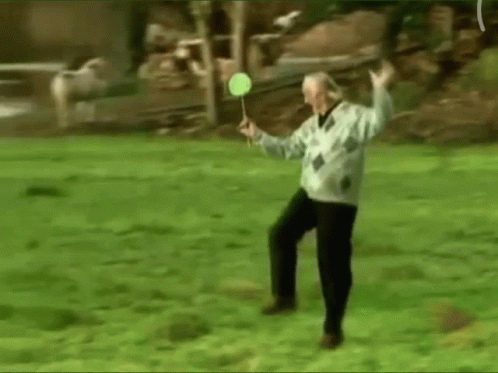 Elderly Man Playing Badminton In Park GIF