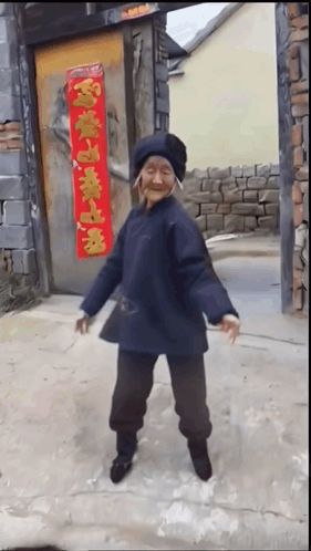 Elderly Woman Dancing In Front Of Door With Chinese Characters GIF