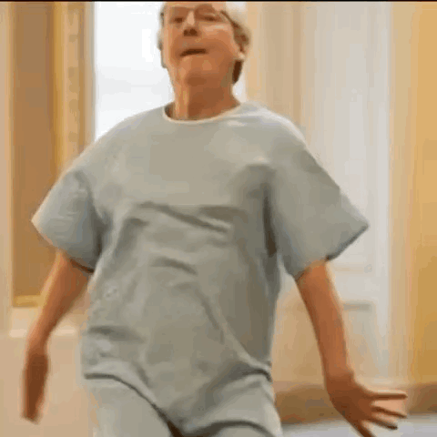 Elderly Woman Dancing in Hospital Gown