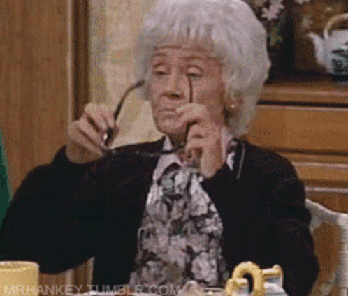 Elderly Woman Holding Glasses GIF