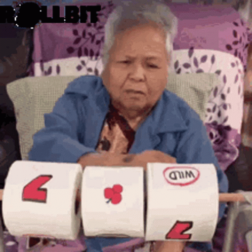 Elderly Woman Holding Toilet Paper Rolls GIF