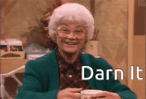 Elderly Woman in Green Jacket Holding Coffee Darn It