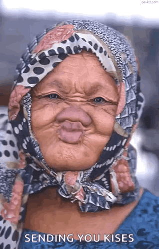 Elderly Woman in Scarf Making Funny Face Blowing Kisses