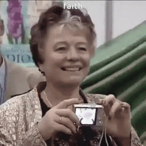 Elderly Woman Smiling Holding Camera With Faith