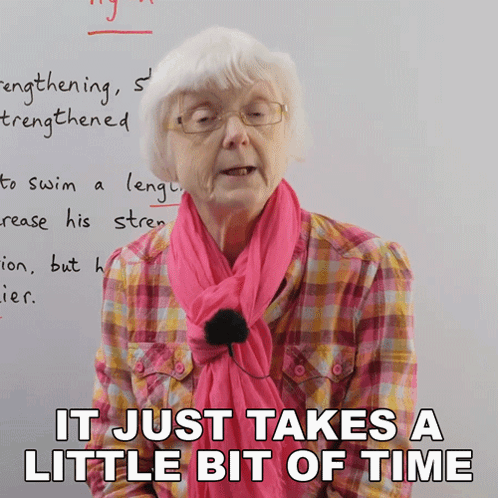 Elderly Woman With Glasses and Pink Scarf Saying It Just Takes a Little Bit of Time