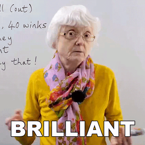 Elderly Woman With Glasses and Scarf Saying Brilliant