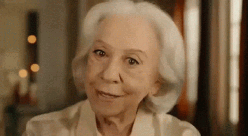 Elderly Woman With White Hair Smiling at Camera