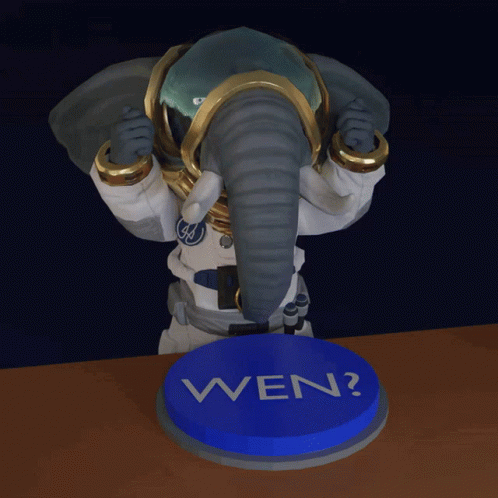 Elephant Statue Standing Next to Blue Button Saying Wen