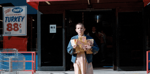 Eleven Walking Out Of Supermarket With Waffles GIF