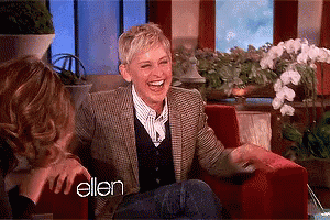 Ellen Degeneres Is Laughing While Sitting In A Chair GIF