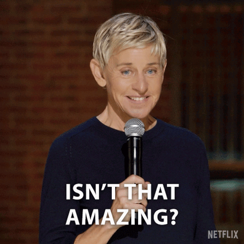 Ellen Degeneres Is Smiling While Holding A Microphone And Says " Isn T That Amazing " GIF