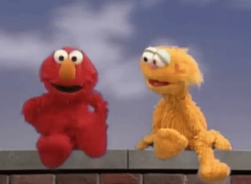 Elmo And Fozzie Are Sitting On A Brick Wall . GIF