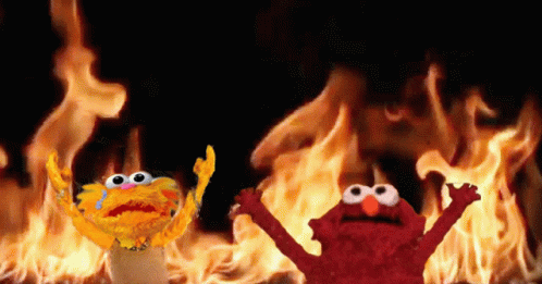 Elmo And Garlic Bread In Front Of Fire GIF