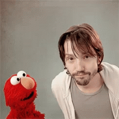 Elmo Dancing And Diego Luna Observing GIF