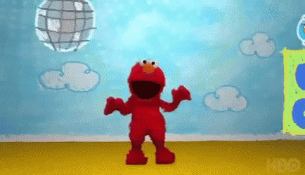 Elmo From Sesame Street Is Dancing In A Room With A Disco Ball . GIF
