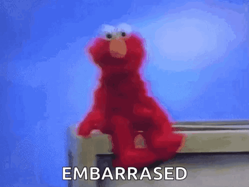 Elmo From Sesame Street Is Sitting On A Window Sill With The Word Embarrassed Written Below Him . GIF