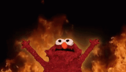Elmo From Sesame Street Is Standing In Front Of A Fire With His Arms Outstretched GIF
