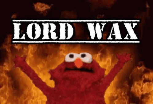 Elmo From Sesame Street Is Standing In Front Of A Fire With The Words Lord Wax Above Him . GIF