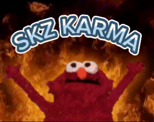 Elmo From Sesame Street Is Standing In Front Of A Fire With The Words " Skz Karma " Written Above Him GIF