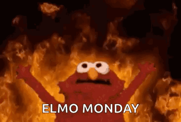 Elmo From Sesame Street Is Standing In Front Of A Wall Of Fire . GIF