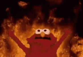 Elmo From Sesame Street Is Surrounded By Flames In A Cave . GIF