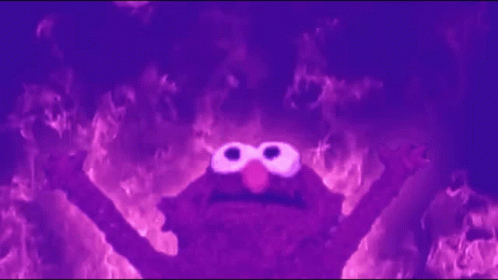 Elmo From Sesame Street Is Surrounded By Flames In A Dark Room . GIF