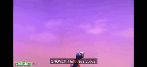 elmo from sesame street is wearing a knight 's helmet and cape