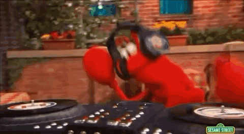 Elmo From Sesame Street Is Wearing Headphones And Playing Records . GIF
