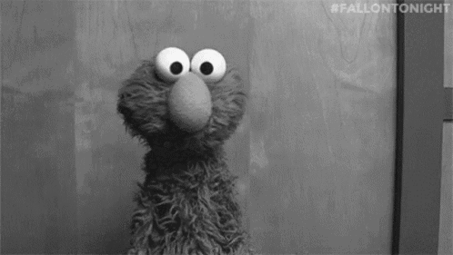 Elmo From Sesame Street Standing in Front of Door Looking at Camera