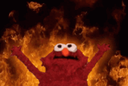 Elmo From Sesame Street Stands In Front Of A Wall Of Flames GIF