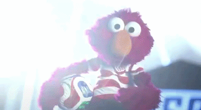 Elmo Holding Soccer Ball In Dark Room GIF