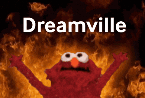 Elmo Is Standing In Front Of A Fire And The Word Dreamville Is Above Him GIF