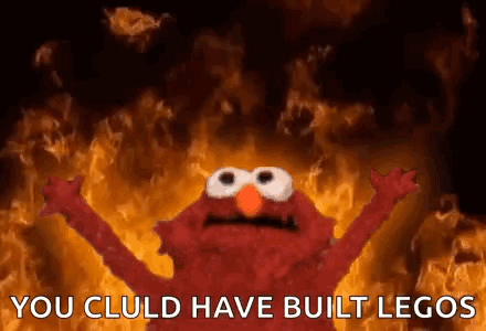 Elmo Is Standing In Front Of A Fire With His Arms Outstretched . GIF