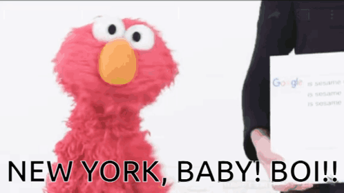 Elmo Sesame Street Next to Person Holding Google Page